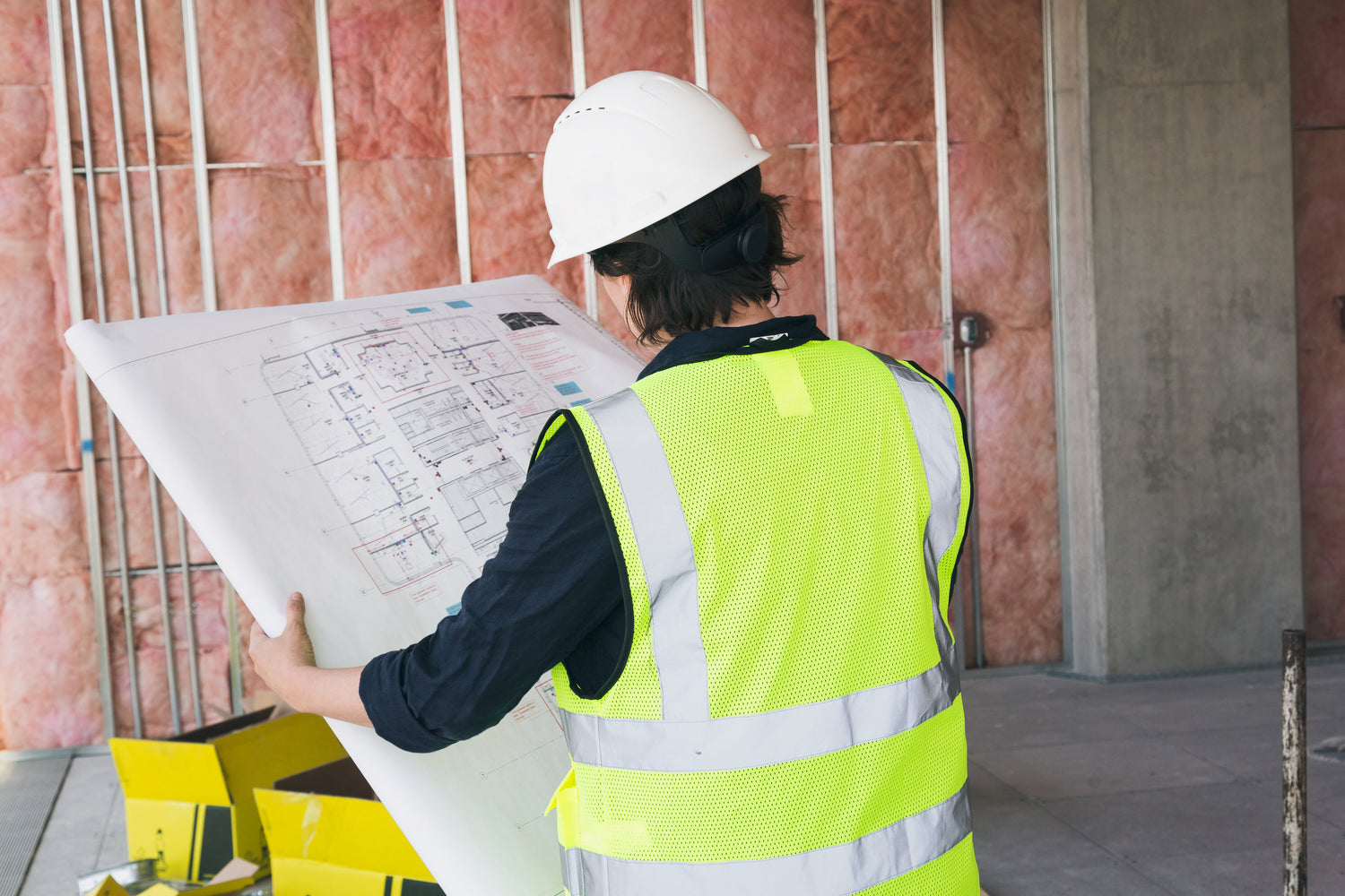 Commercial Construction Project worker holding prints